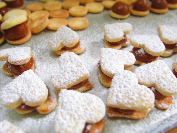 Saborea la tradición con nuestros exquisitos alfajorcitos clásicos, disponibles en distintas formas y rellenos para satisfacer todos los gustos.