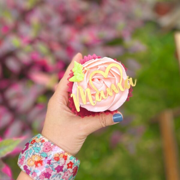 Seis cupcakes decorados con rosetones de buttercream y topper de Mamá con medio corazón.