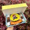 Mix Box de Mario decorado en fondant con trufas, brownies y alfajores, acompañado de un banner que dice “Feliz Día del Niño”